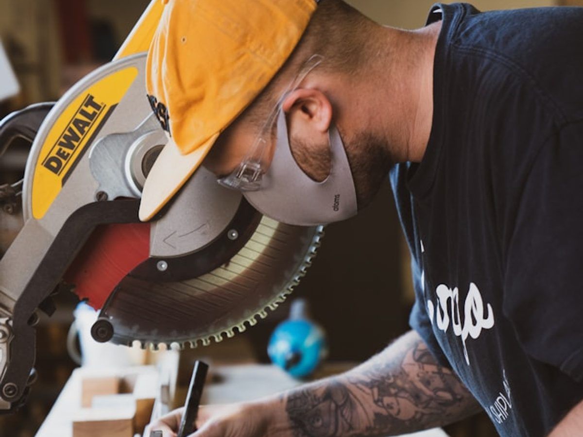 Carpenter cutting wood on a workbench