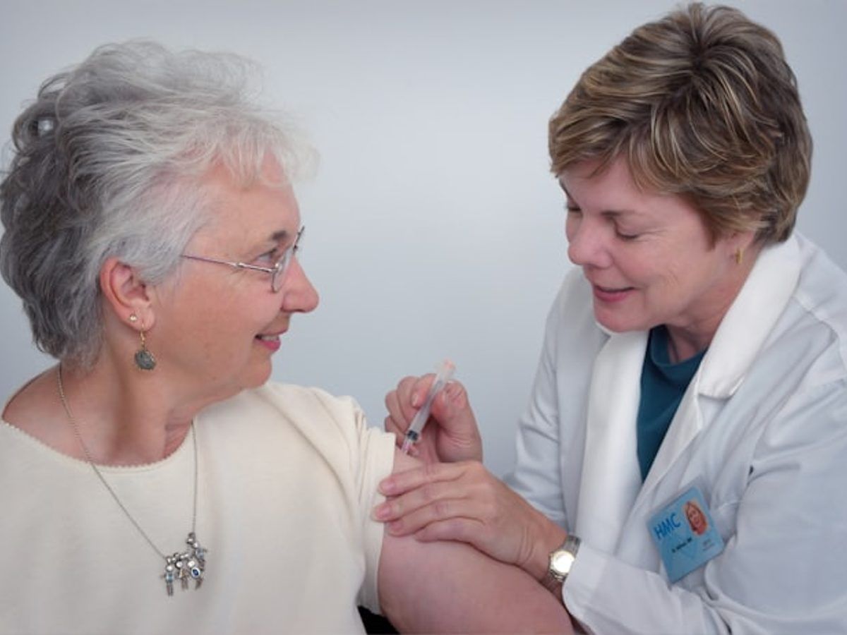 Nurse assisting an elderly patient